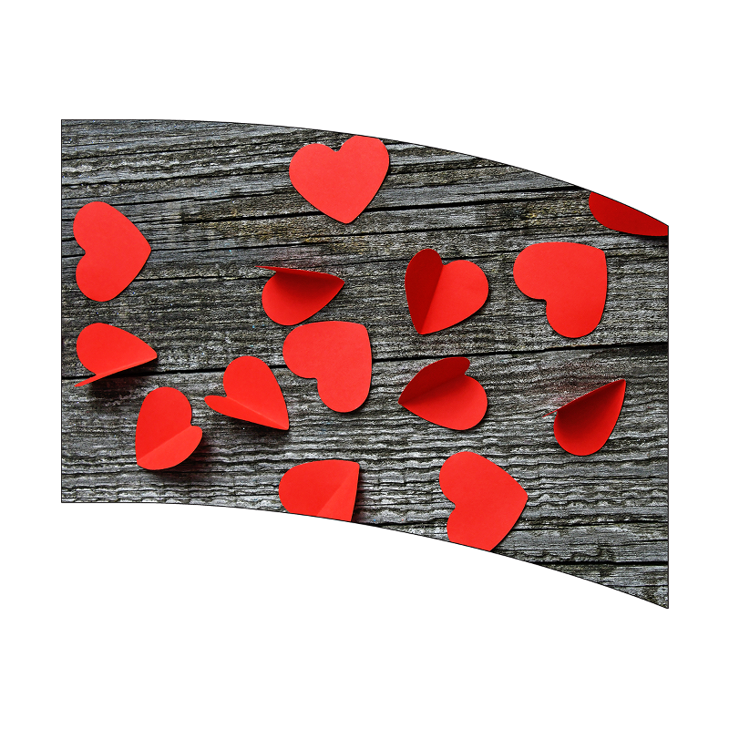 Red heart-shaped confetti on a wooden surface