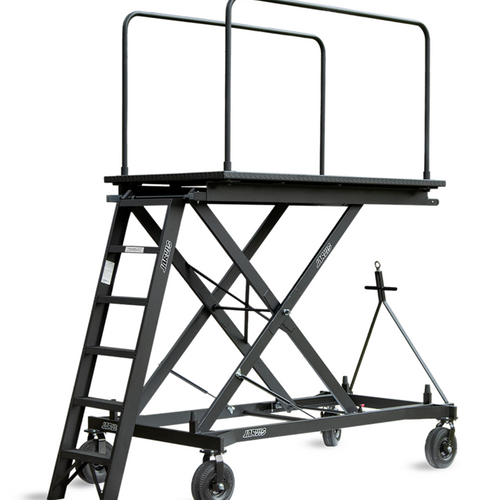 Jarvis 6-foot ScissorLift Podium Model 15 featuring an elevated conductor platform with dual safety railings, heavy-duty steel scissor-lift frame, integrated access ladder, and rolling caster wheels, designed for secure use in marching band rehearsals and field performances.
