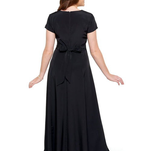 Back view of the Denise sweetheart neck short sleeve dress in black, showcasing a fitted waist with tie-back detail and a flowing floor-length skirt, ideal for choir performances, formal events, and stage wear.