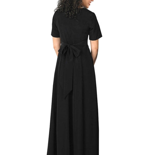 Zelda scoop neck short sleeve dress shown from the back in black, featuring a graceful full-length skirt and adjustable tie-back detail, worn by a model for choir performances, stage productions, recitals, and formal ensemble wear.