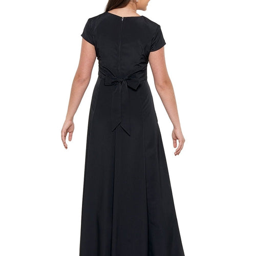 Back view of the Sabrina V-Neck Cap Sleeve Dress in classic black, featuring a floor-length flowing skirt, cap sleeves, and an elegant waist tie detail, designed for show choir performances, formal events, and coordinated group ensembles.