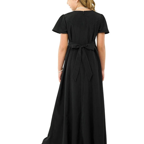 Back view of Joyce High Scoop Neck flutter sleeve dress in black, showcasing a floor-length silhouette with soft flutter sleeves and a tied waist detail, ideal for choir, show choir, and formal performance ensembles.