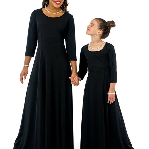 Natalie scoop neckline 3/4 sleeve black dress shown on an adult and youth model holding hands, featuring a full-length flowing silhouette ideal for choir performances, formal events, and coordinated stage wear.