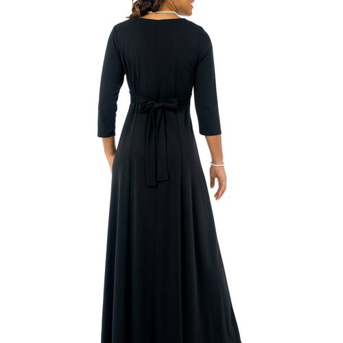 Natalie scoop neckline 3/4 sleeve black dress shown from the back, featuring a full-length flowing skirt with an adjustable waist tie, designed for elegant choir performances, formal events, and stage presentations.