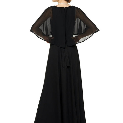 Back view of the Destiny boat neck cape dress in black, showcasing the sheer flowing cape sleeves, elegant boat neckline, and floor-length silhouette, designed for formal choir, concert, and stage performance wear.