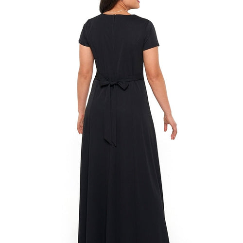 Hayley Sweetheart Neck Short Sleeve Dress in black, featuring a floor-length flowing skirt with a fitted bodice and waist tie detail, shown in back view to highlight clean lines and elegant silhouette for formal events and choir performances.
