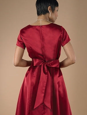 Back view of the Sarah Sweetheart Neck Short Sleeve Satin Dress, showcasing a floor-length satin gown with a fitted bodice, elegant waist tie bow, and smooth flowing silhouette, ideal for formal occasions, performances, and special events.