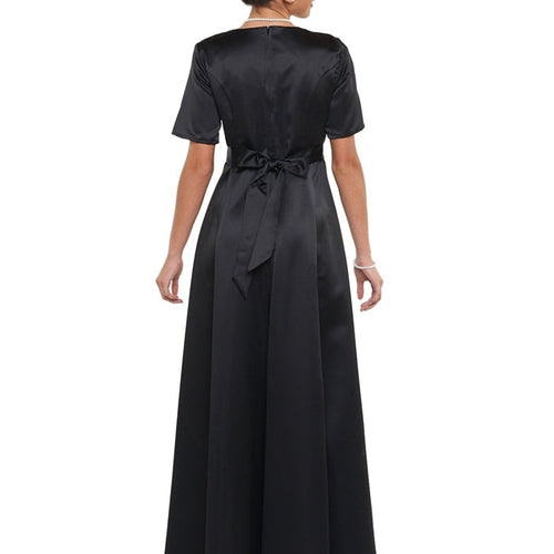 Back view of the Zoey scoop neck short sleeve dress in black, featuring a smooth satin finish, waist tie detail, and full-length flowing skirt, designed for formal events, choir performances, and elegant stage appearances.