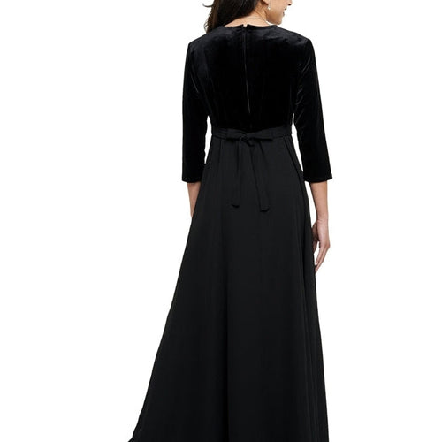 Back view of the Alexandra Velvet Heart Neck 3/4 Sleeve Dress in black, showcasing a smooth velvet bodice, three-quarter sleeves, fitted waist with tie-back detail, and a flowing floor-length skirt, ideal for formal performances, show choir events, and elegant stage wear.