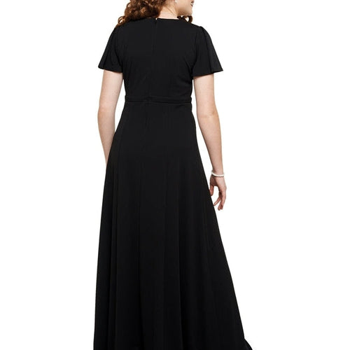 Back view of the Sophia Crossover Flutter Sleeve Dress in black, showcasing a fitted waist, flutter sleeves, and a flowing floor-length skirt, designed for show choir performances, formal stage wear, and concert attire.