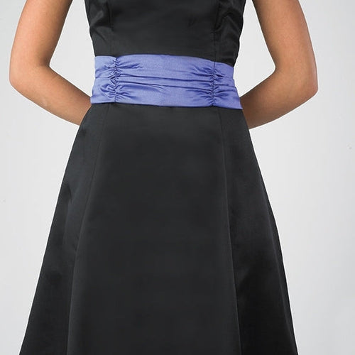 Tanya cummerbund sash in satin blue worn over a black sleeveless performance dress, featuring ruched detailing at the waist, designed for choir uniforms, concert performances, formal stage wear, and dance ensembles.