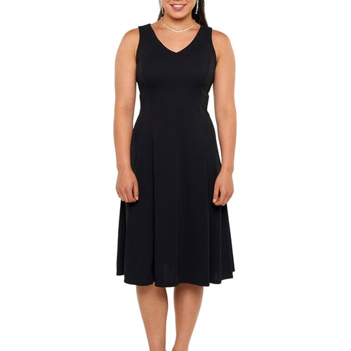 Libby V-neck sleeveless show choir dress in black, featuring a fitted bodice, flowing knee-length skirt, and classic performance-ready silhouette, worn by a female performer on a white background.