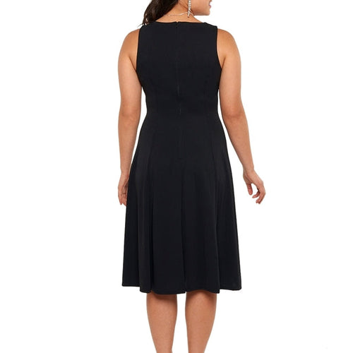 Back view of the Libby V-neck sleeveless show choir dress in black, showcasing a clean sleeveless design, tailored fit, and flowing knee-length skirt for stage and performance wear.