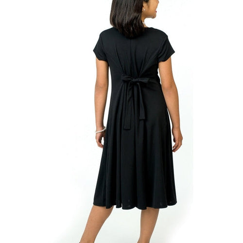 Paris cowl neck cap sleeve show choir dress in black, back view featuring flowing A-line skirt and tie-back waist detail.