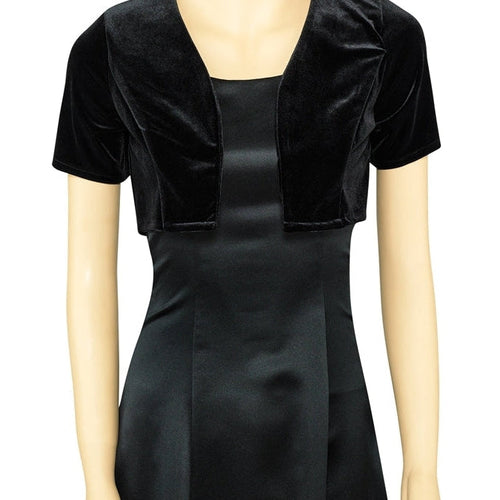 Ariana short sleeve bolero jacket in black velvet, shown on mannequin over a fitted dress, featuring a cropped open-front design ideal for formal, evening, or special occasion wear.
