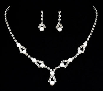 Rhinestone and pearl necklace set with matching drop earrings, featuring white pearls and sparkling crystal accents on a silver-tone chain, displayed on a black background, ideal for formal events, weddings, concerts, and elegant stage performances.