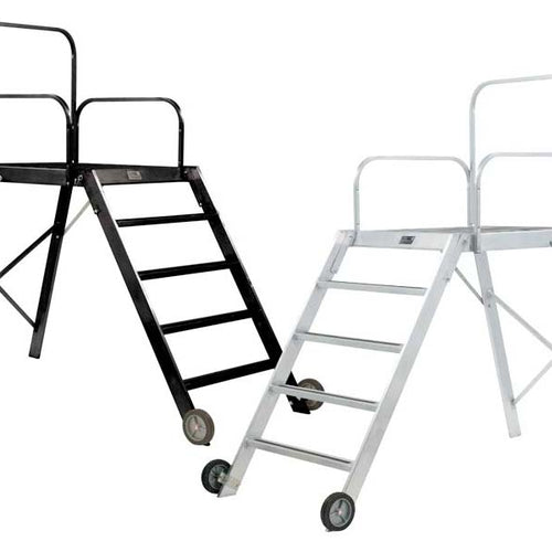 DSI 52-inch conductor podium available in black and silver finishes, featuring sturdy aluminum frame, elevated standing platform, safety rails, ladder access, and transport wheels for marching band and drum major performances.