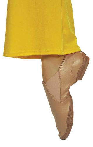 Close-up side view of DSI StarLite 2 nude jazz dance shoes worn during movement, showcasing smooth leather upper, elastic side panels for flexible fit, low stacked heel, and lightweight sole designed for jazz dance, stage performances, and studio practice.